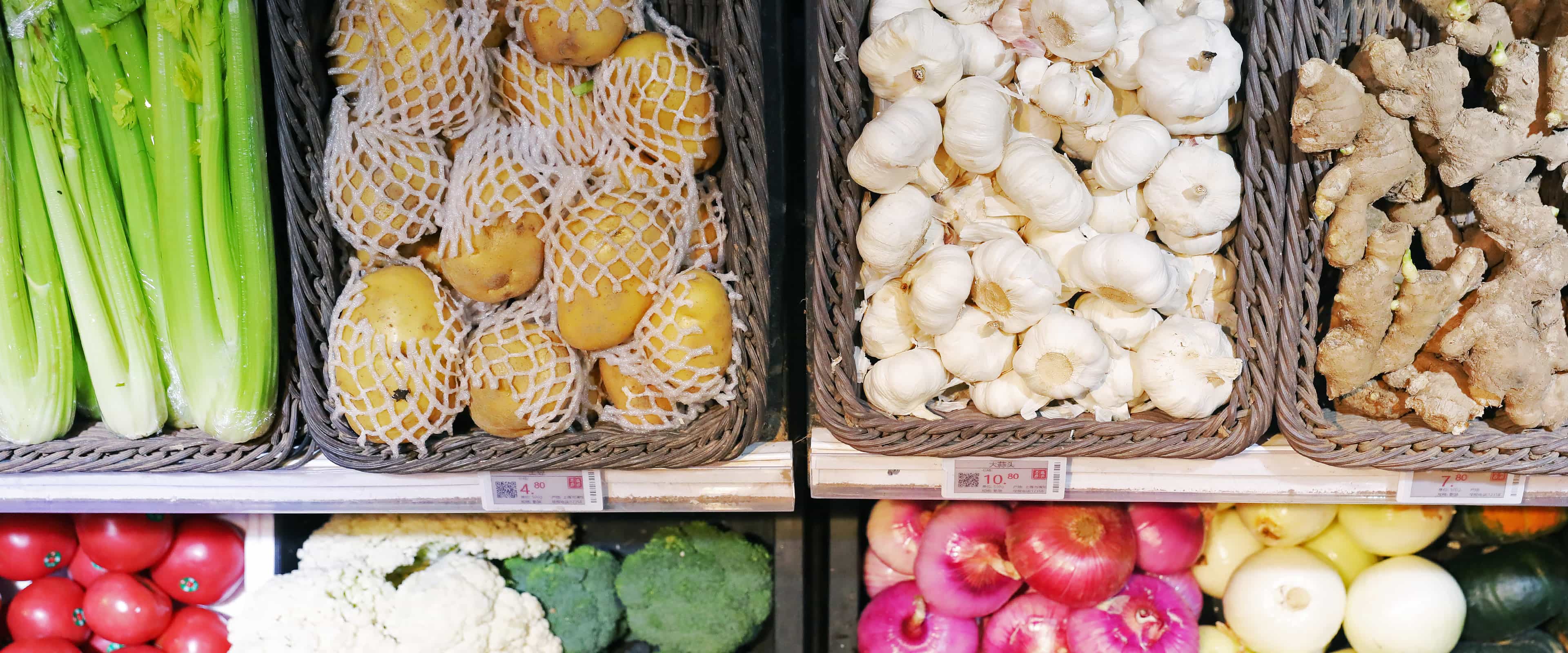 Digital price tags on supermarket vegetable display shelves