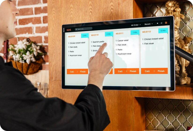 Chef checking preparation times on FLEX 3 kitchen display