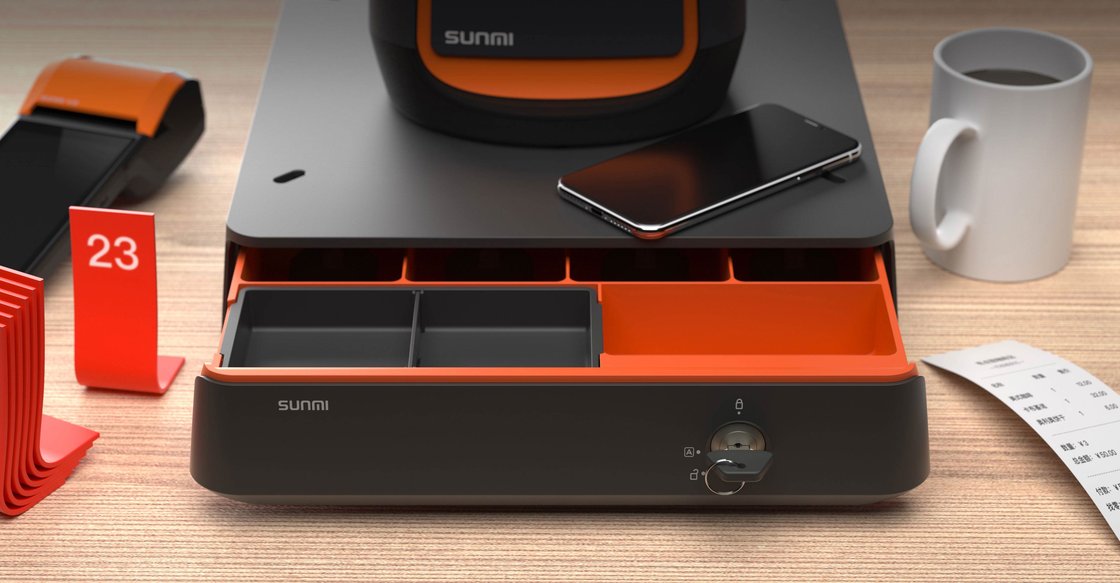 Black and orange Sunmi cash drawer with orange interior, phone, receipt, and mug, illustrating smart software integration for security and a tidy POS workspace.